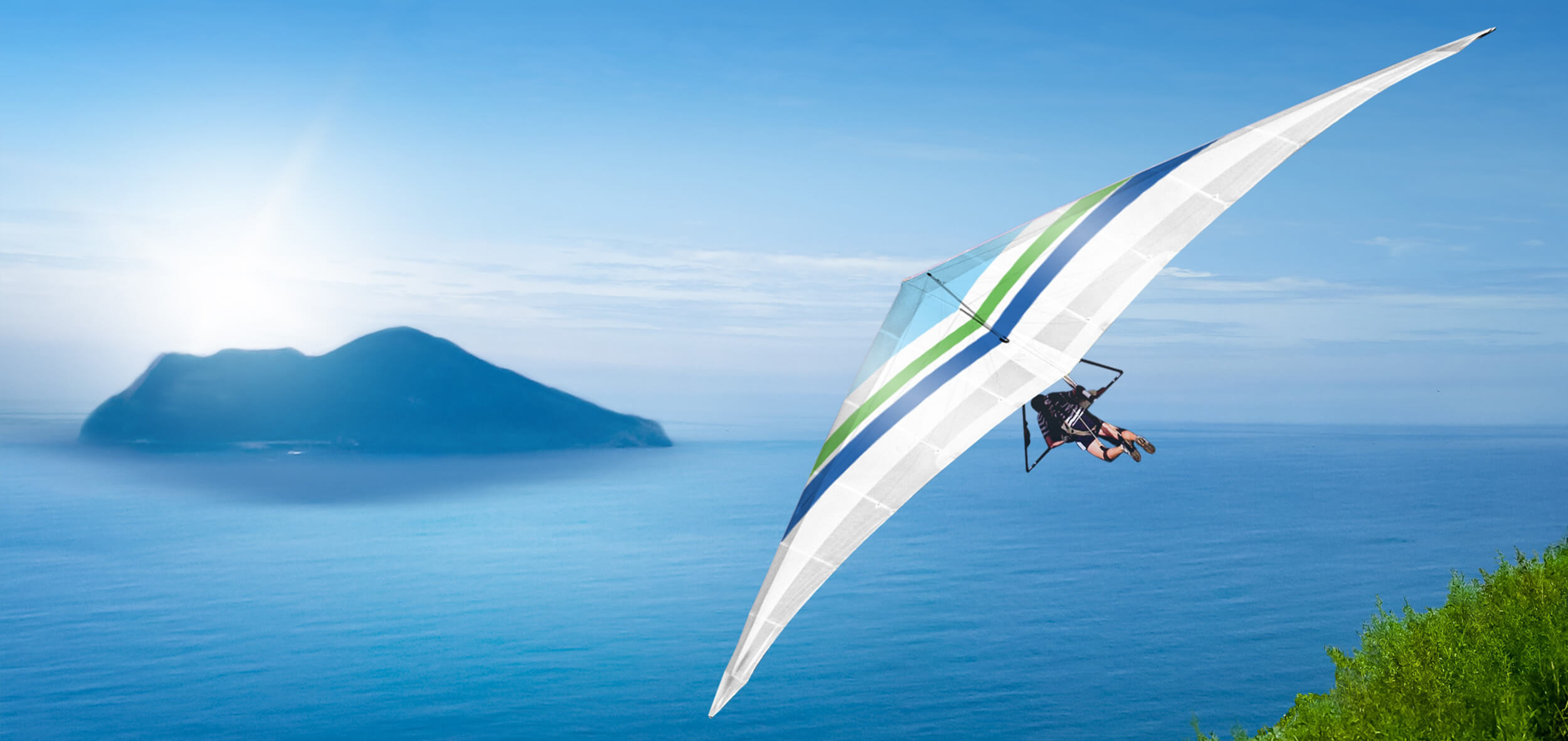 Paraglider flying over the sea